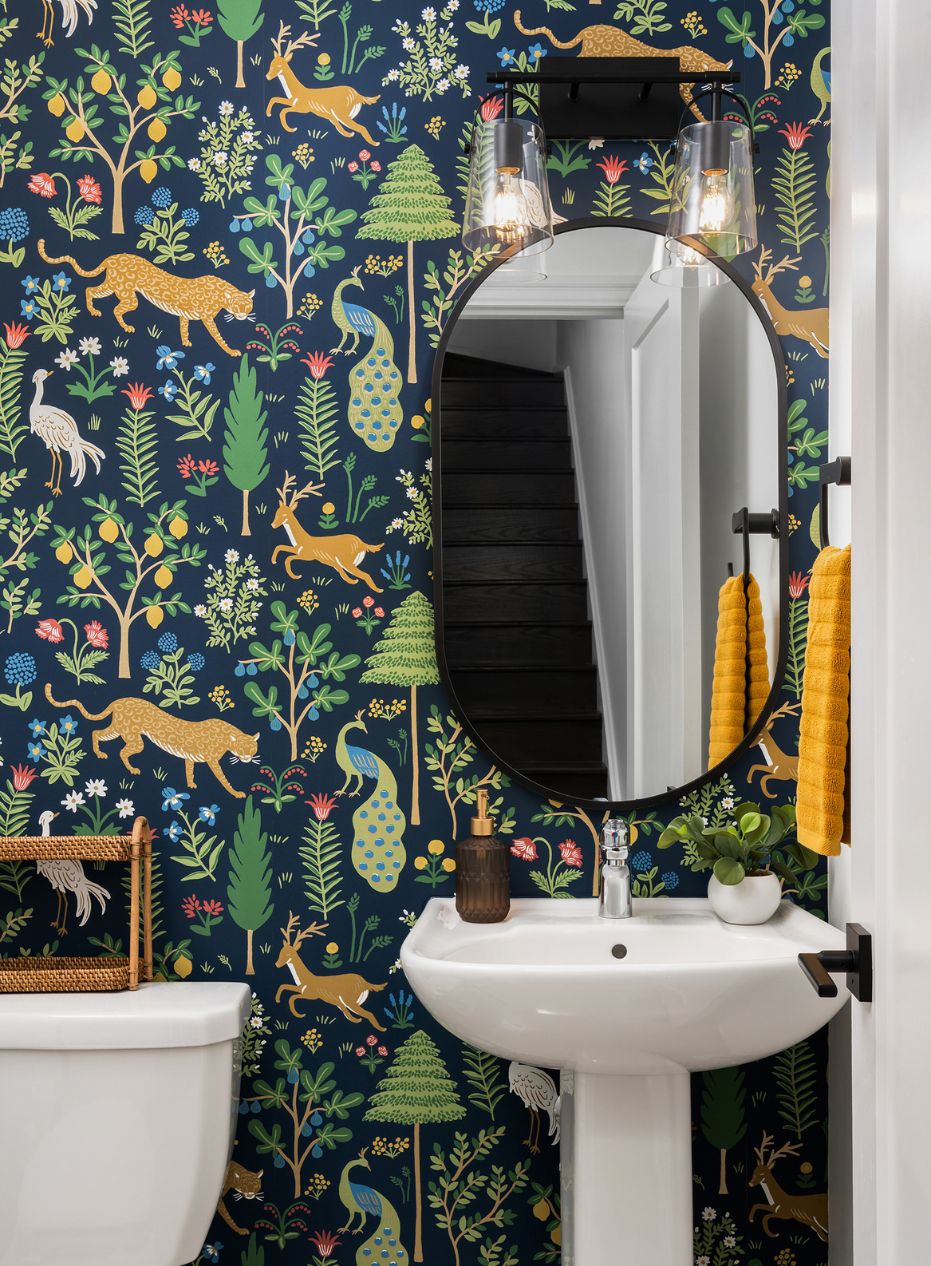 Playful Modern Powder Room Small powder room with colourful wallpaper including various illustrated animals and plants