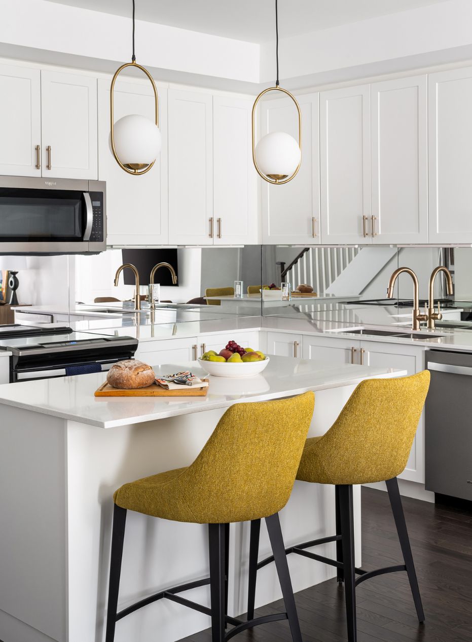 White and Gold Kitchen Townhouse kitchen with white cabinets, gold hardware and yellow counter stools