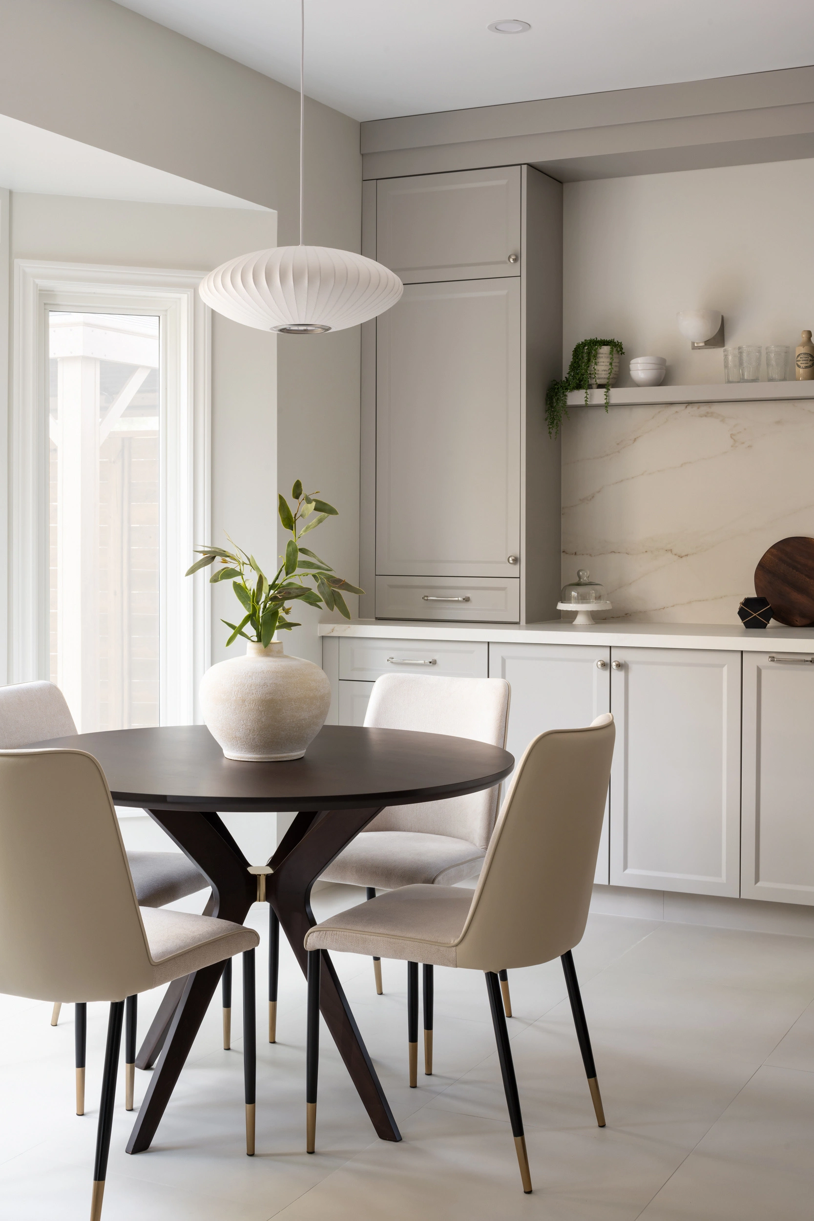 Open-concept kitchen renovation featuring white cabinetry, wood accents, and a quartz backsplash in a contemporary home